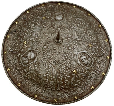 Lot 402 - AN ITALIAN EMBOSSED SHIELD IN THE MILANESE RENAISSANCE STYLE